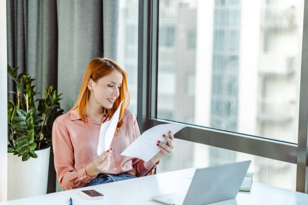 istock Young businesswoman looking at project papers 1405817025