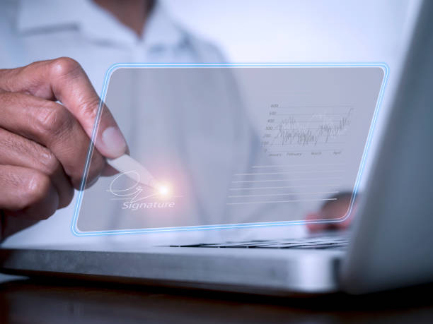 istock businessman use electronic pen sign signature on electronic  E-signing, data sheet document management, paperless office concept. Businessman using stylus pen signing e document on digital tablet. 1405818665