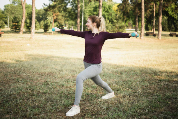 istock Happy young woman doing a strength training outdoors 1405822371