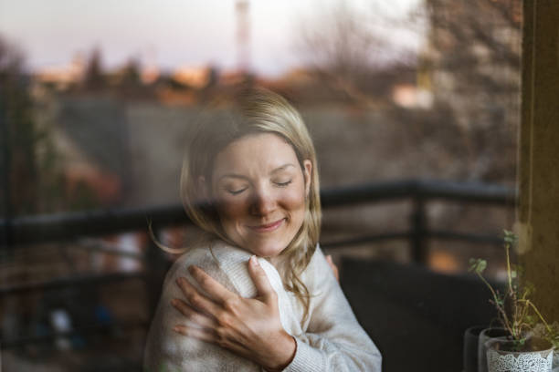 istock Smiling loving young woman hugging oneself 1405831234