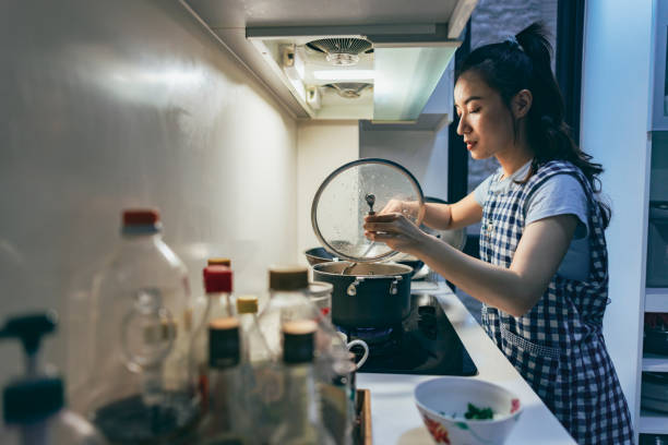 A young Asian mother prepares dinner