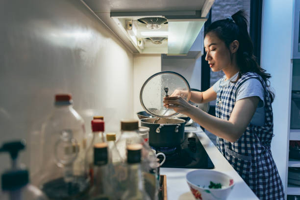 a young asian mother prepares dinner - choicesea 個照片及圖片檔