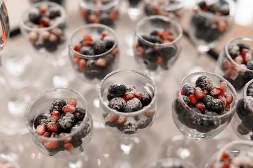Frozen berries in a glass. Dessert for a party in a restaurant.