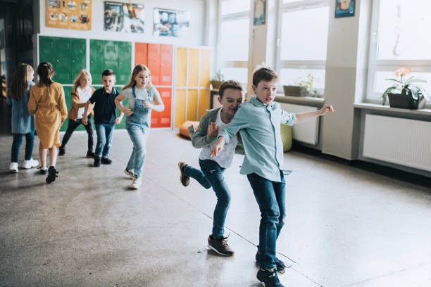 istock group of elementary school children running in the corridor 1405832815