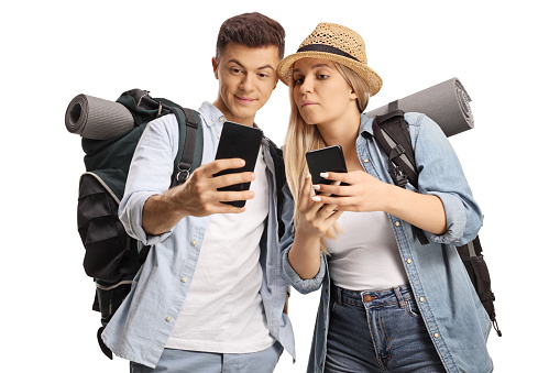 Male and female backpackers holding smartphones isolated on white background