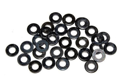A group of washers to be used for the assembly of a deck chair lays sorted and ready for use.