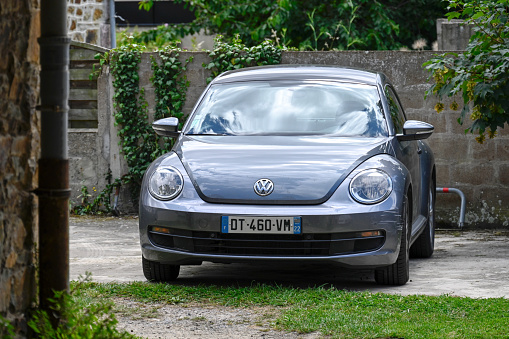 Pléneuf-Val-André, France, June 28, 2022 - A Volkswagen New Beetle parked on the Atlantic beach in Brittany . The Volkswagen New Beetle (2011-2019) was produced in Puebla (Mexico).