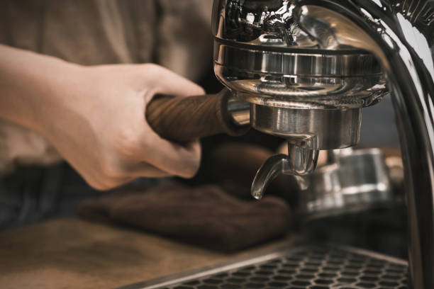 istock Espresso pouring from coffee machine. coffee machine preparing fresh coffee and pouring into red cups at restaurant, bar or pub. Brew coffee 1405836036