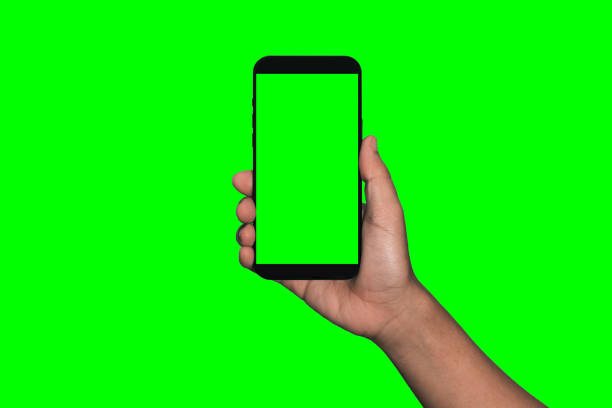 istock Businessman hand holding black smartphone isolated on white background, white clipping path inside. 1405836046