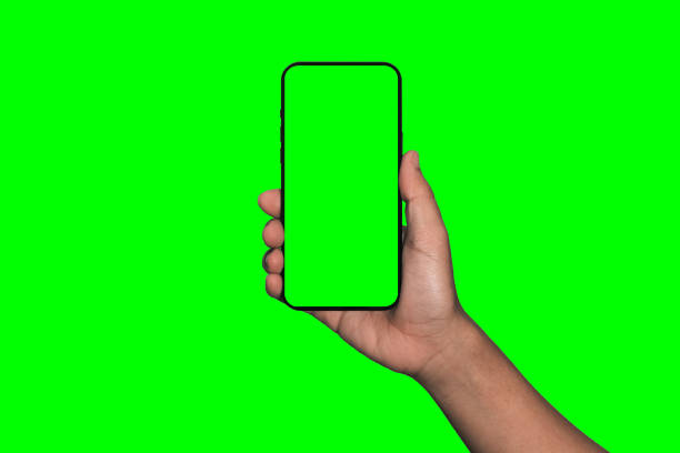 istock Businessman hand holding black smartphone isolated on white background, white clipping path inside. 1405836054