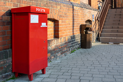 red mailbox on a red brick wall