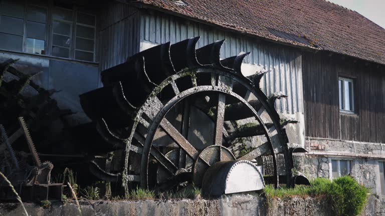 Old waterwheel mill. Water wheel turning water. Water falls on old water wheel