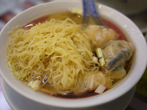 Close up High angle view of hong kong wonton dumpling egg noodle soup in a bowl, tradition local food, chinese menu
