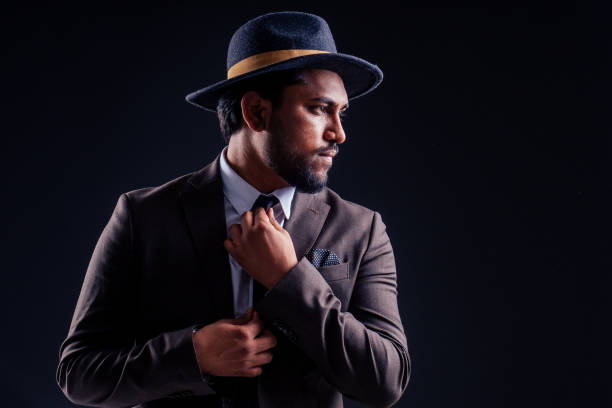 istock indian business man wearing hat and classic suit on black background in studio 1405839697