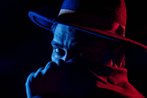 istock Young handsome model posing in a studio in a trendy neon light in a stylish suit and hat 1405839703