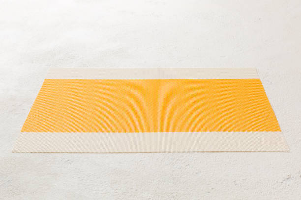 istock Perspective view of yellow tablecloth for food on cement background. Empty space for your design 1405841737
