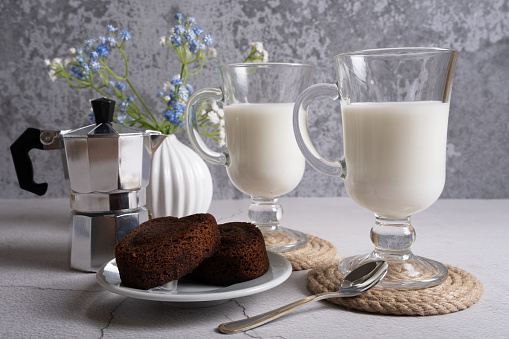 Milk in clear glasses with dessert for breakfast