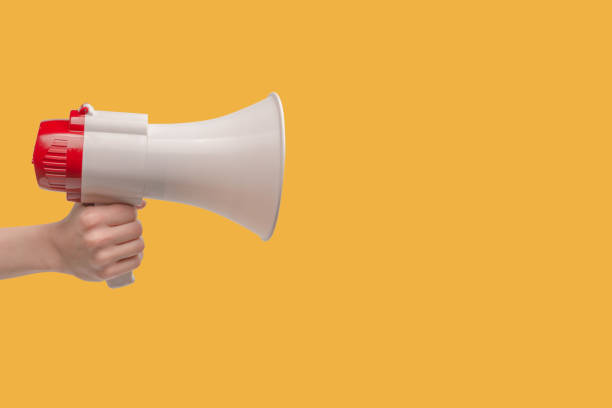 istock Megaphone in woman hands on a white background. 1405843680