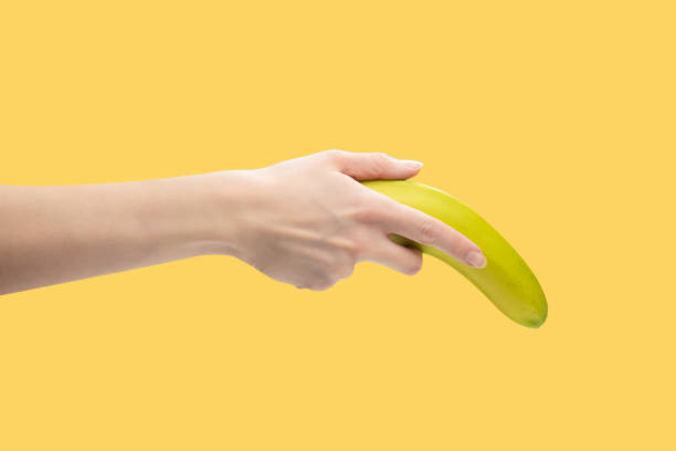 istock A bunch of bananas in woman hand isolated on white background. 1405843708
