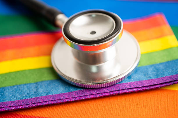 Black stethoscope with rainbow flag heart on white background, symbol of LGBT pride month  celebrate annual in June social, symbol of gay, lesbian, bisexual, transgender, human rights and peace. stock photo