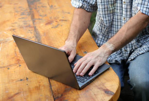 istock person typing on a laptop standing 1405845408