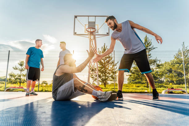 istock Man helping the injured teammate to get up 1405846632