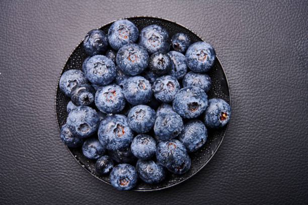 blueberries in black background stock photo