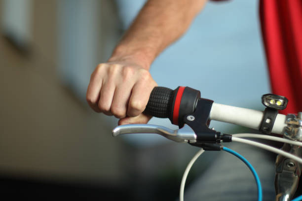 istock a hand holding a handlebars of a bicycle 1405847054
