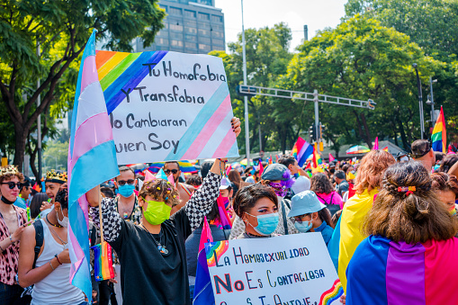 Mexico City, Mexico; June 25 2022: people holding signs with texts of apollo por el argullo, lgtb, lgbtq+. text in Spanish.