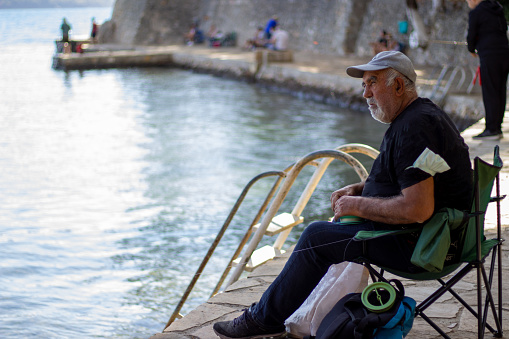 old man fishing by the sea