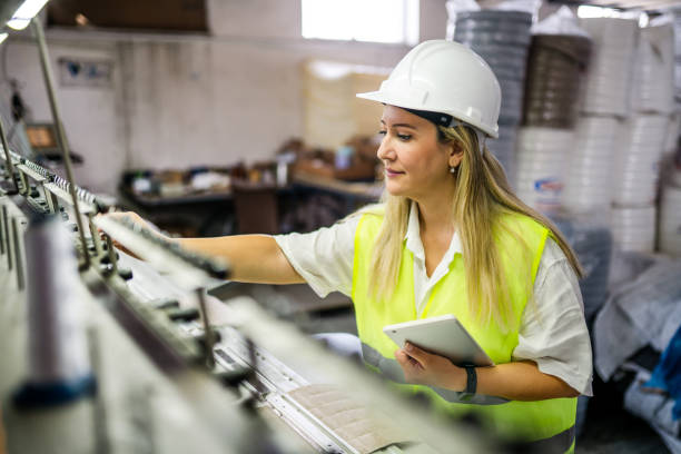 Female engineer working with manufacturing equipment in a factory