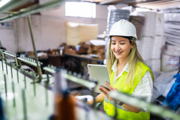 istock Female engineer working with manufacturing equipment in a factory 1405848752
