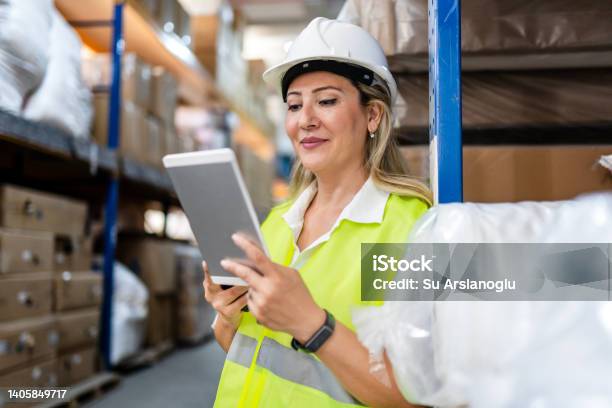Female Engineer Doing Quality Control In A Factory Stock Photo - Download Image Now