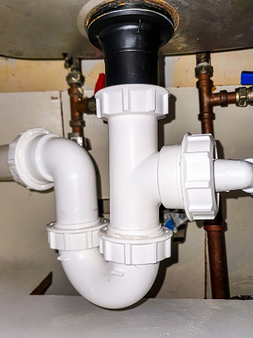 A PVC under sink pipe layout to take waste water from kitchen or bathroom to the waste water sewage system below.