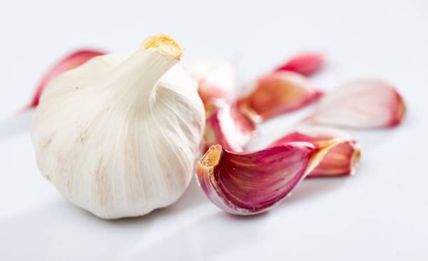 istock Whole garlic with separated cloves, isolated on a white background 1405851509