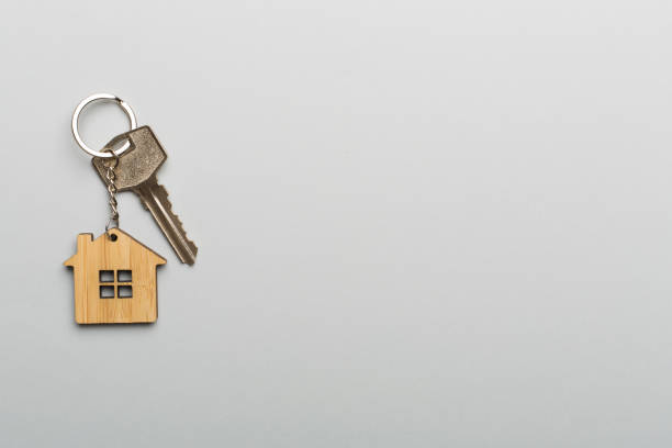 istock Keys with house-shaped keychain on color background 1405852990