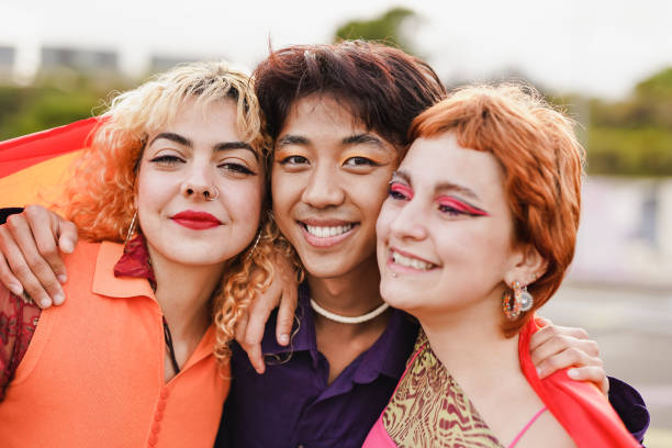 istock Young diverse people having fun at LGBT pride parade while smiling on camera 1405854355