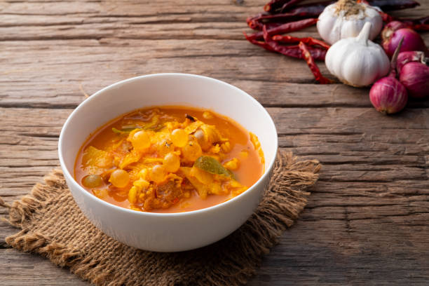 yellow spicy giant catfish soup mix with catfish small egg and bamboo shoot