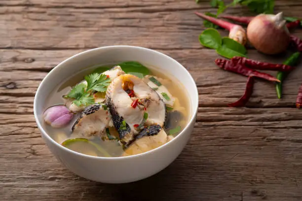 Spicy snake head fish soup ,Thai hot and sour soup call Tom yum pla in white bowl