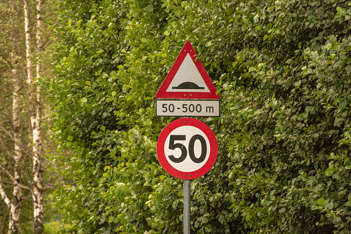 Lindesnes, Norway - August 07 2021: Traffic signs warning for speed bumps ahead.