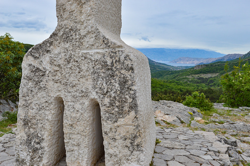 Baska, Krk island, Croatia - May 7th 2022. Glagolitic letter A placed at viewpoint above Baska bay. Glagolitic script is the oldest known Slavic alphabet dating from 9th century. Sculptor: Ljubo de Karina, academic sculptor. The sculpture was placed on the 13th December 2006