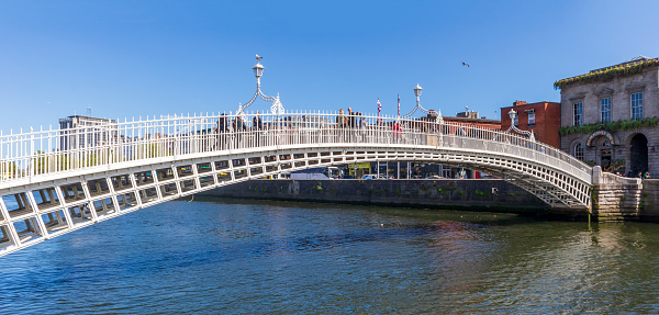Dublin, Ireland - June 1, 2022: Ha'penny Bridge and officially the Liffey Bridge, a pedestrian bridge built in May 1816 over the River Liffey in Dublin