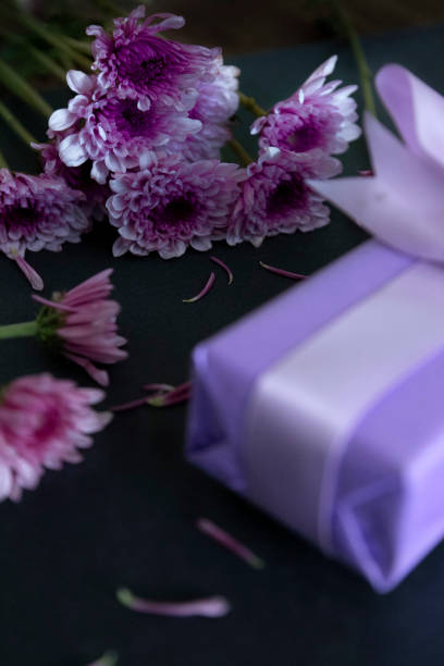 istock table decorated with gifts and Chrysanthemum violet 1405859165