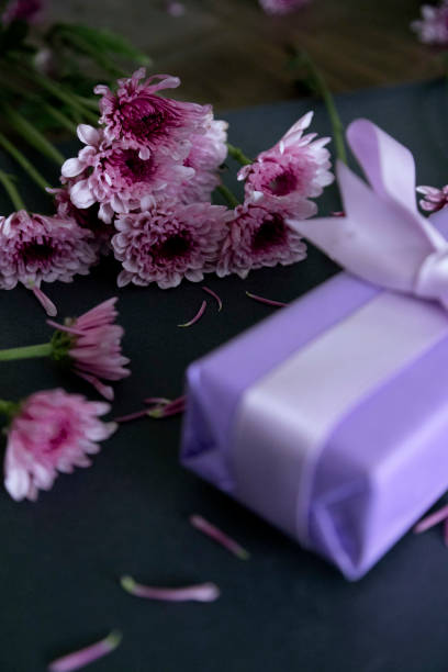 istock table decorated with gifts and Chrysanthemum violet 1405859197