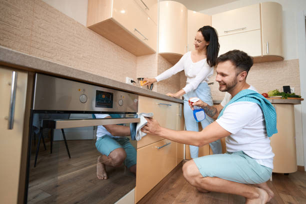 istock Husband and wife cleaning kitchen together with detergent 1405861341