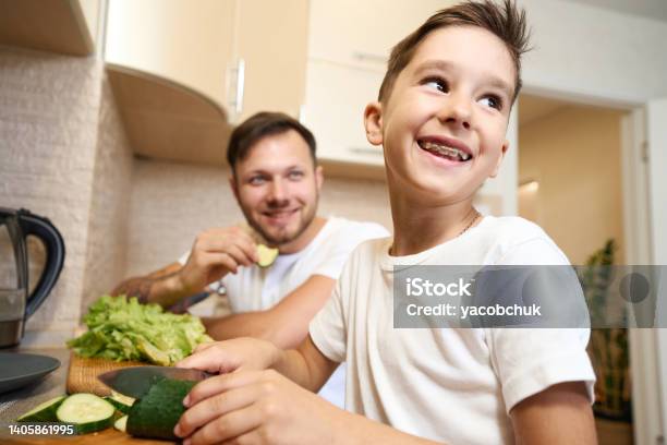 Boy With Teeth Braces Smiling While Cutting Cucumber Stock Photo ...