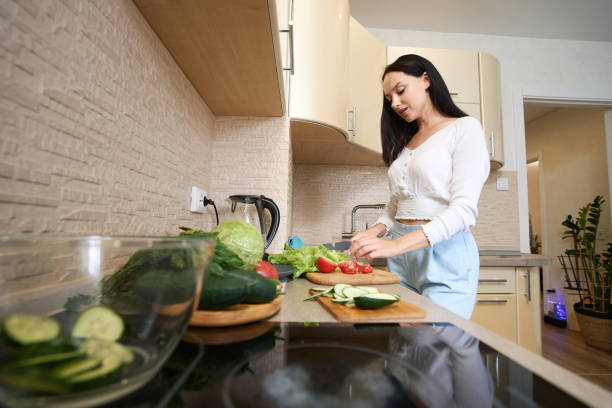 istock Housewife cooking salad alone in the kitchen 1405862015