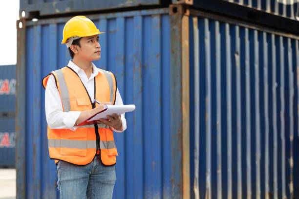 istock factory worker or engineer writing on clipboard in containers warehouse storage 1405863458