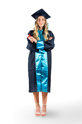 Full length graduation portrait of beautiful blonde woman with cap and gown isolated on white background
