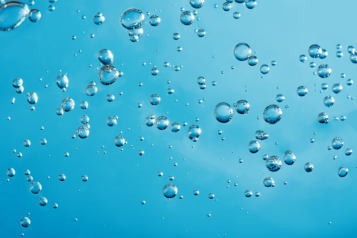 Water drops on white background. Abstract drops of gel. Face serum cosmetics.